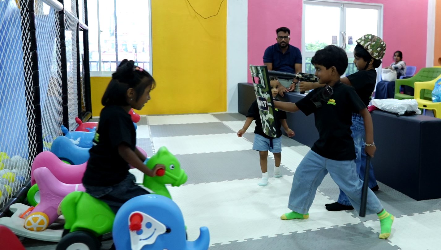 Children playing together while parents relax nearby
